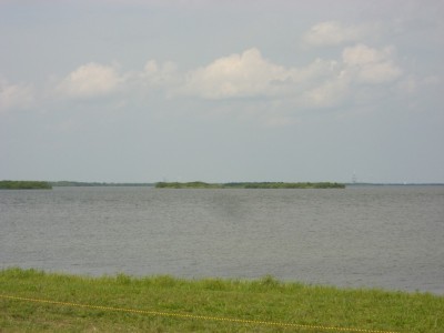 This is a view from the NASA Causeway of launch pad 39A (to the right, somewhat hard to see).Taken without zoom lens, it closely resembles what you see with your eyes. The Causeway viewing area is around six miles away from the pad.