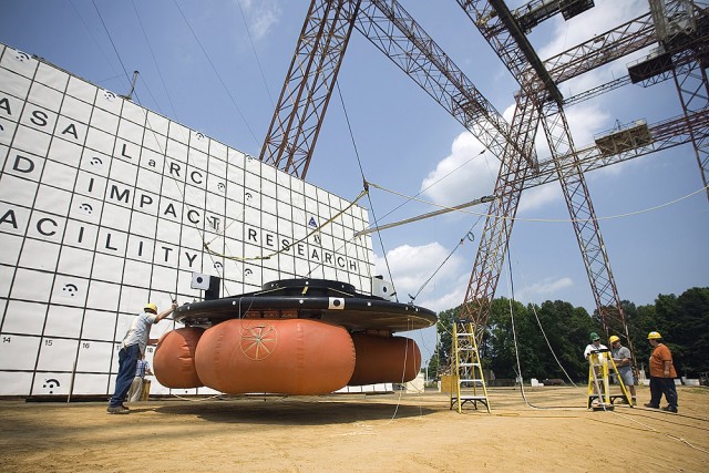 Engineers at NASA Langley's Landing and Impact Research Facility prepare for an airbag drop test of the Orion crew exploration vehicle. These tests are helping researchers determine the best technology for returning Orion to Earth.
Credit: NASA/Sean Smith