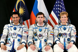 The Expedition 16 crew (to the middle and left) before launch to ISS