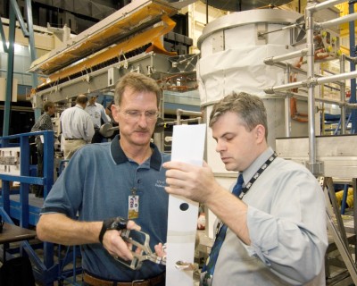 Astronaut Joseph R. Tanner, left, works with David H. Mothers of USA on possible ISS solar array repair procedures to be used by STS-120 spacewalkers.<br />Photo Credit: NASA