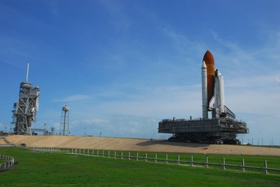 Space Shuttle Discovery, atop a mobile launch platform, climbs the five percent grad to the top of the hardstand at Launch Pad 39A.