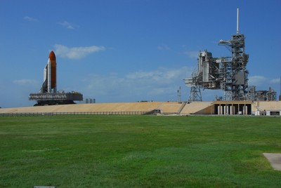 Space Shuttle Discovery, atop a mobile launch platform, climbs the five percent grad to the top of the hardstand at Launch Pad 39A.