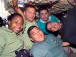 Expedition 16 Flight Engineer Daniel Tani (bottom), Mission Specialists Stephanie Wilson and Doug Wheelock (second left), Expedition 16 Flight Engineer Yuri Malenchenko and Pilot George Zamka take a moment for a photo on the middeck of Space Shuttle Discovery while docked with the International Space Station. Image credit: NASA