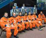 Attired in training versions of their shuttle launch and entry suits, the STS-123 crew members await the start of a training session in the Space Vehicle Mockup Facility at Johnson Space Center. From the right are astronauts Dominic L. Gorie, commander; Gregory H. Johnson, pilot; Richard M. Linnehan, Japan Aerospace Exploration Agency's (JAXA) Takao Doi, Robert L. Behnken, all mission specialists; Garrett E. Reisman, Expedition 16 flight engineer; and Michael J. Foreman, mission specialist. Image credit: NASA