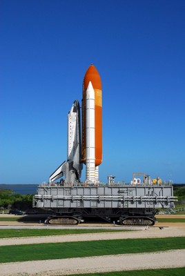 The crawler transporter, moving Space Shuttle Discovery atop its mobile launch platform from the Vehicle Assembly Building, follows the path to Launch Pad 39A.
