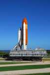 The crawler transporter, moving Space Shuttle Discovery atop its mobile launch platform from the Vehicle Assembly Building, follows the path to Launch Pad 39A.