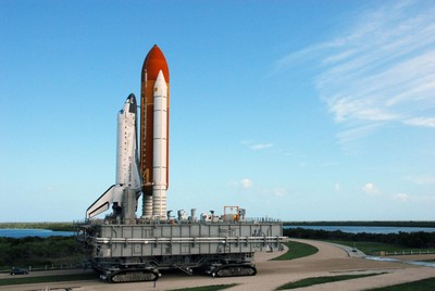 The crawler transporter, moving Space Shuttle Discovery atop its mobile launch platform from the Vehicle Assembly Building, heads in the direction of Launch Pad 39A.