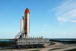 The crawler transporter, moving Space Shuttle Discovery atop its mobile launch platform from the Vehicle Assembly Building, heads in the direction of Launch Pad 39A.