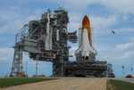 Access platforms at Launch Pad 39A are moved into position against Space Shuttle Discovery on a balmy Florida afternoon.